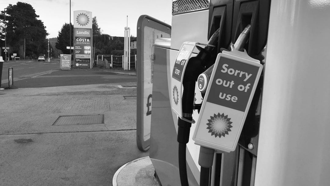 a gas pump with a sign saying sorry out of use, illustrating Brent oil price