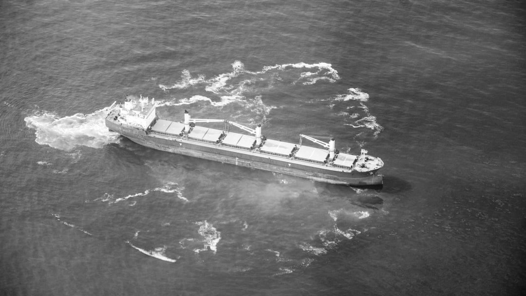 A cargo ship is sailing in the open ocean, illustrating Brent oil price