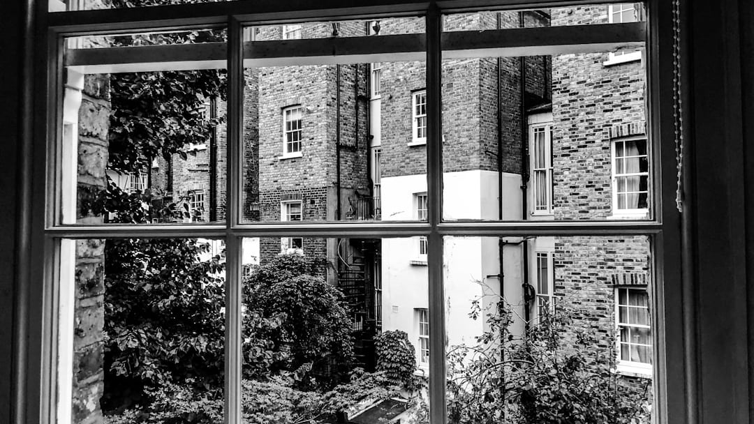 View of buildings and trees through a window, illustrating London stamp duty property market