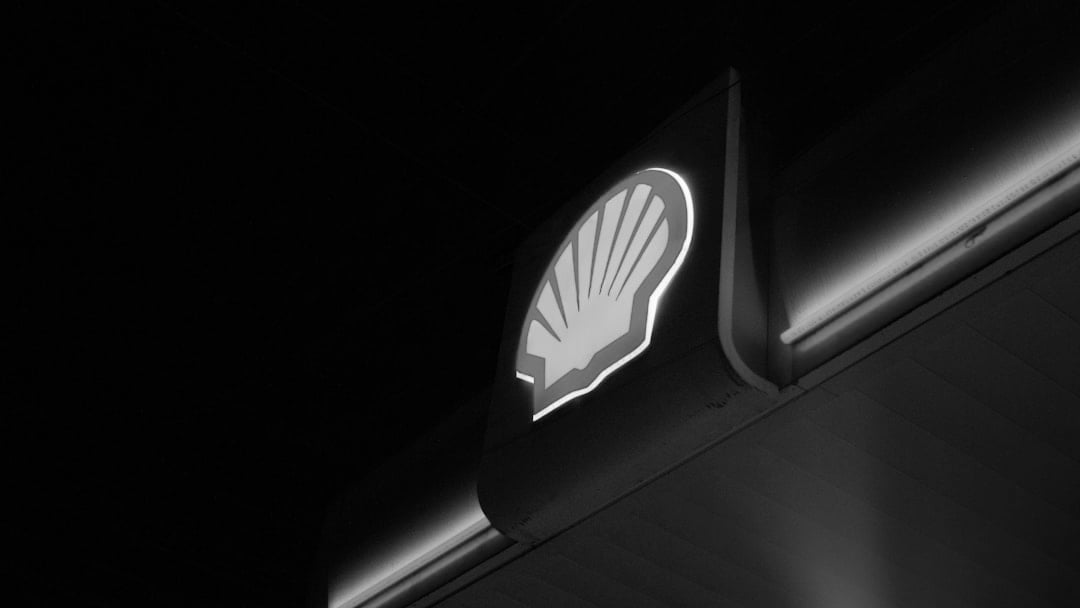 Shell logo illuminated at night with neon lights, context for Shell ARC Resources deal