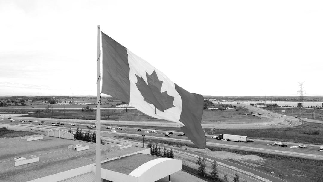 a canadian flag flying in the wind on top of a building (Shell), context for Shell ARC Resources deal