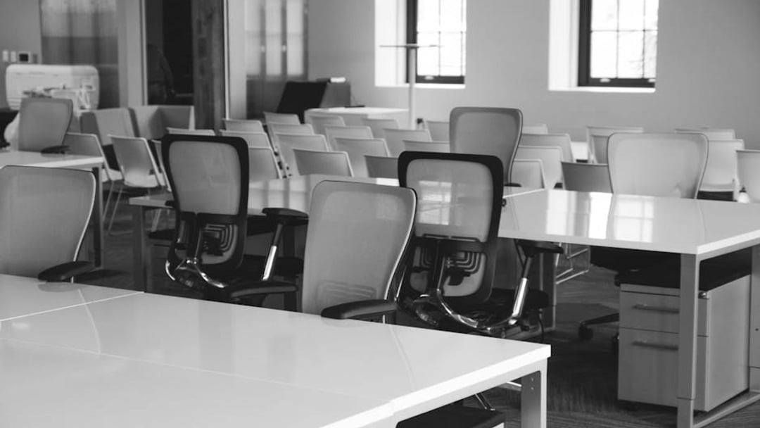Spacious open office workspace with desks, chairs, and natural lighting — symbolising GDP