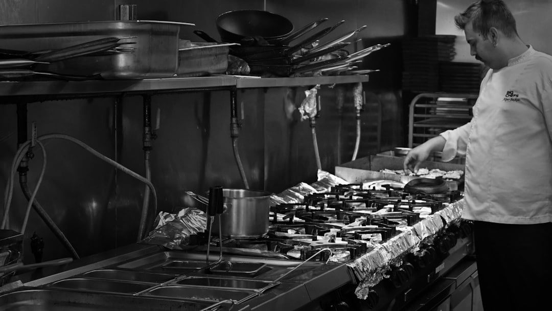 A chef cooking in a commercial kitchen (Whitbread), context for Whitbread share price uk