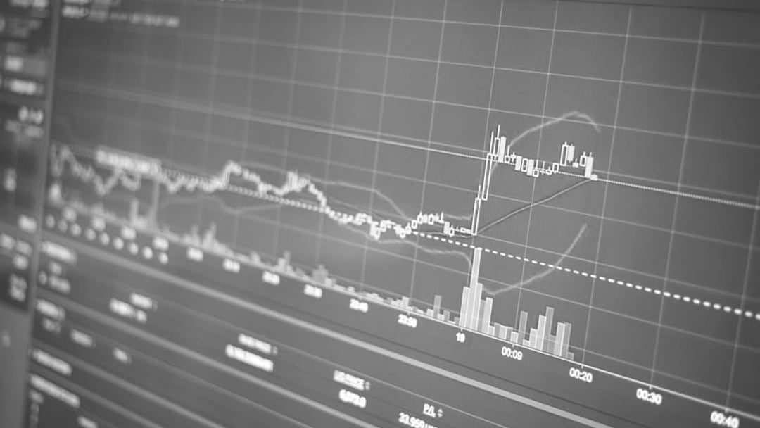 Close-up of a financial graph on a screen showing stock market trading data and trends, illustrating Brent oil price