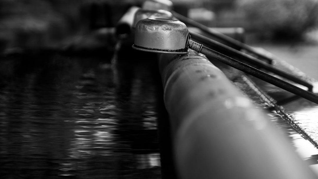a close up of a metal pipe with water running down it, illustrating FTSE 100 dividend stocks
