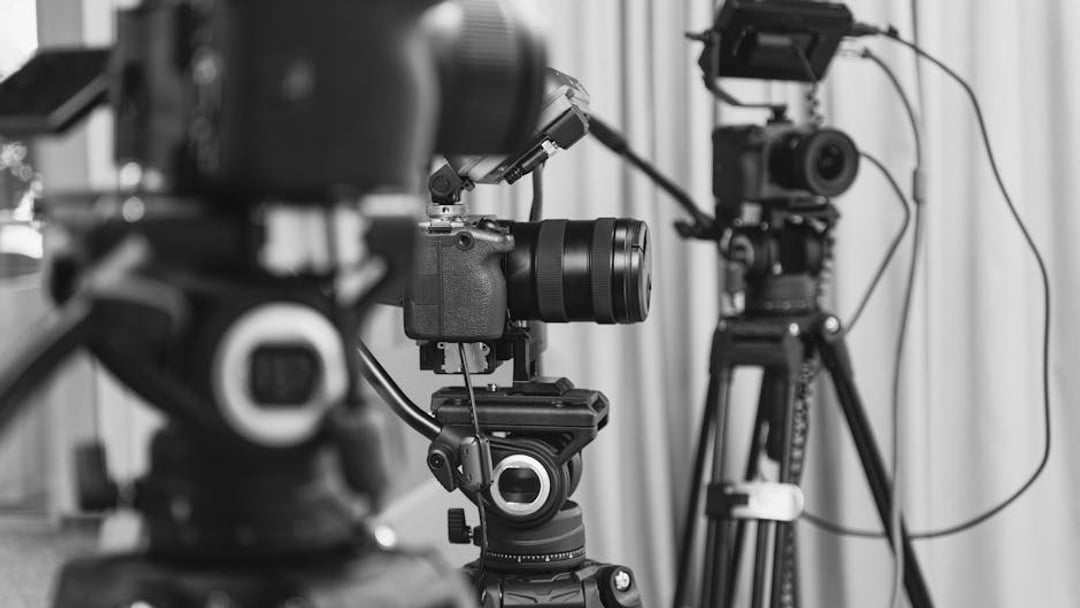 Close-up of high-end video cameras and tripods in a modern studio setting, illustrating Sky Sports F1 deal