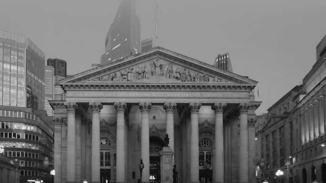Stunning view of the Royal Exchange building in London during twilight, illustrating UK PMI job cuts