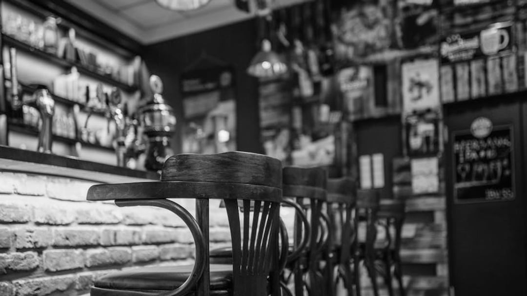 Warm, inviting pub interior featuring rustic wooden chairs in a laid-back setting, illustrating UK pub closures business