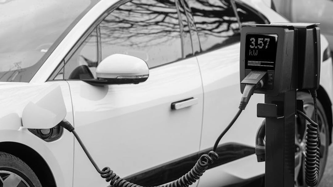 Close-up of an electric vehicle charging at a station, showcasing energy-efficient technology, illustrating Volkswagen share